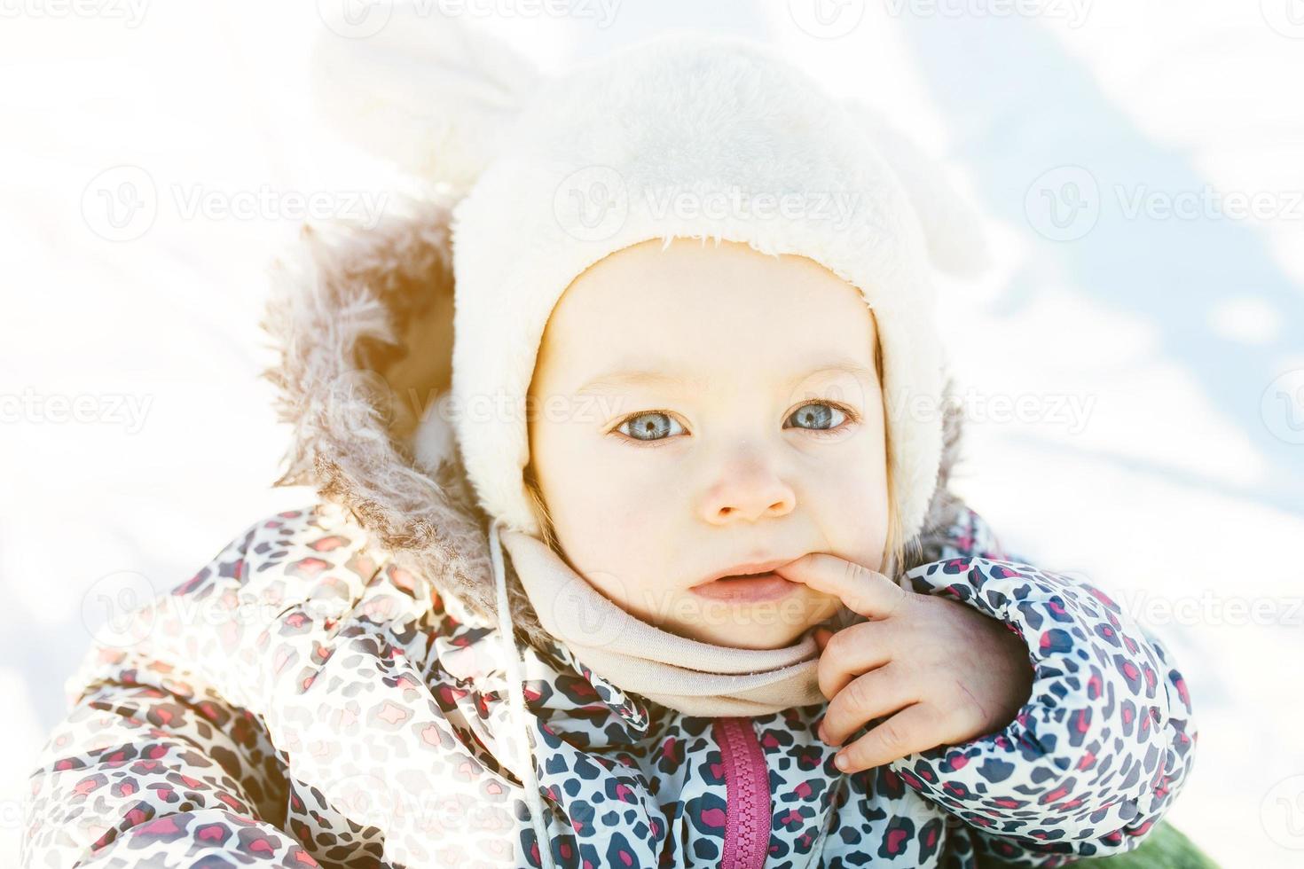 little girl walks in the snow photo