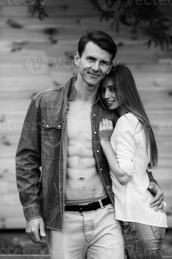 couple posing on a background of the wooden wall photo