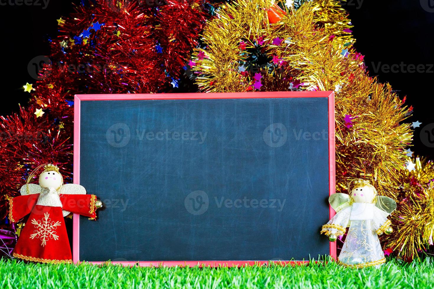 Snow man on green grass with chalkboard photo