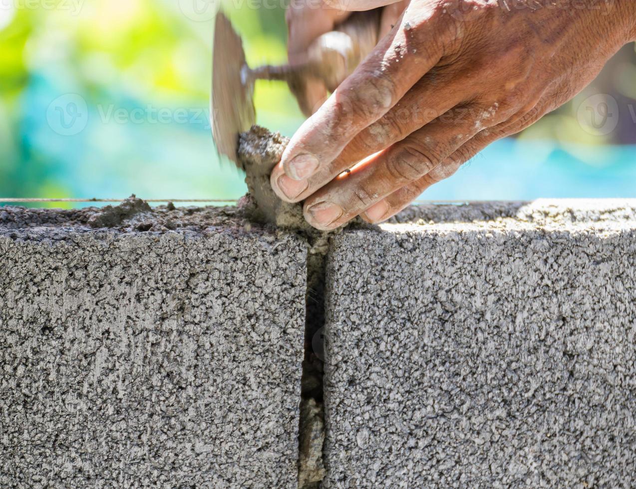 Bricklayer working in site photo