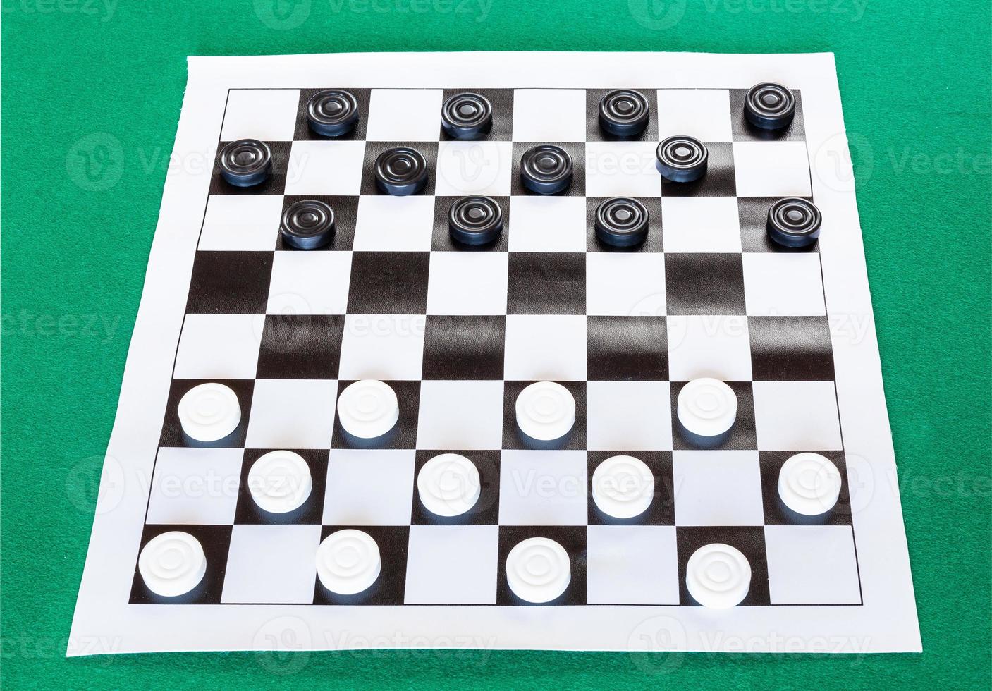 checkers on black and white checkered sheet board photo