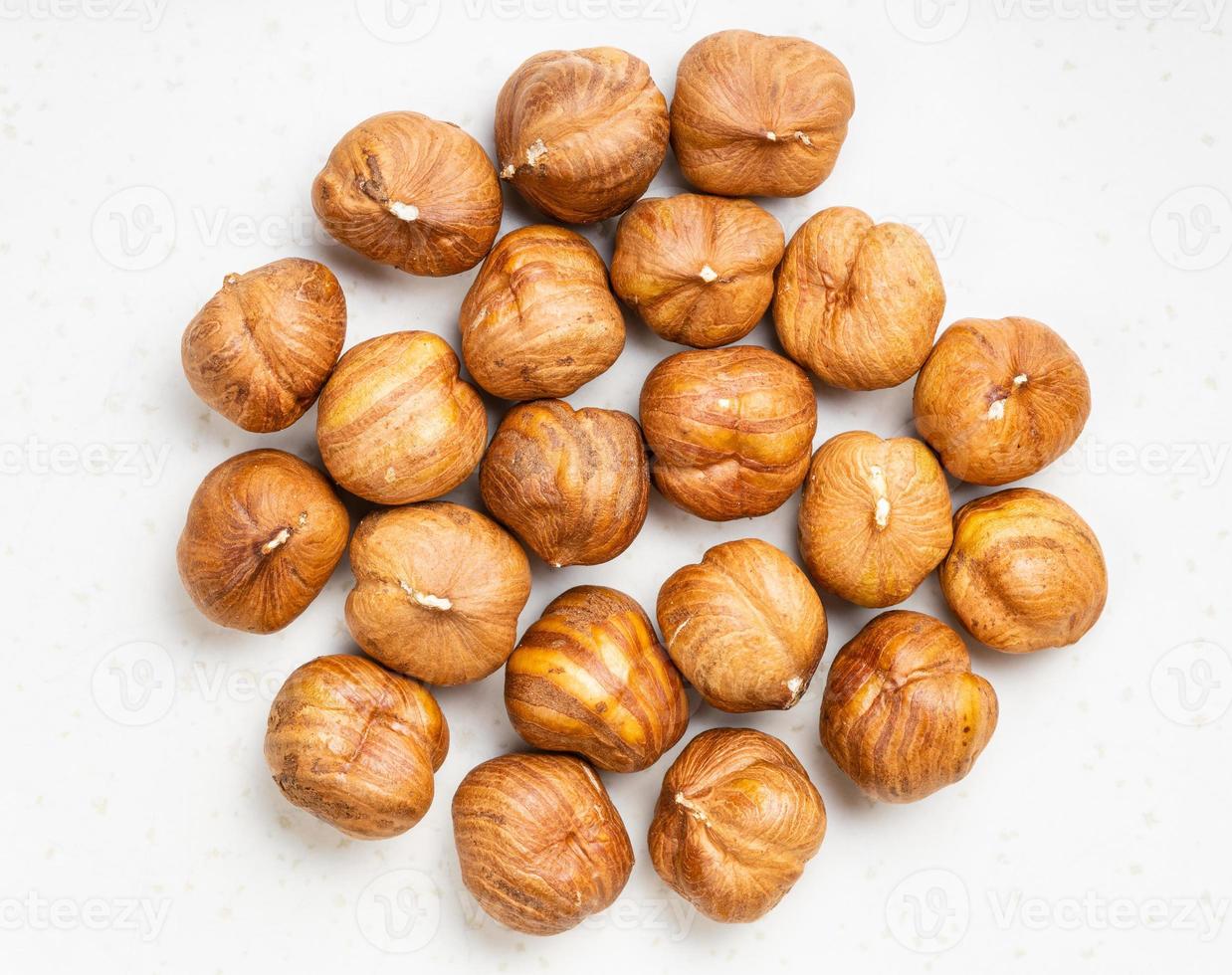 top view of pile of shelled hazelnuts on gray photo