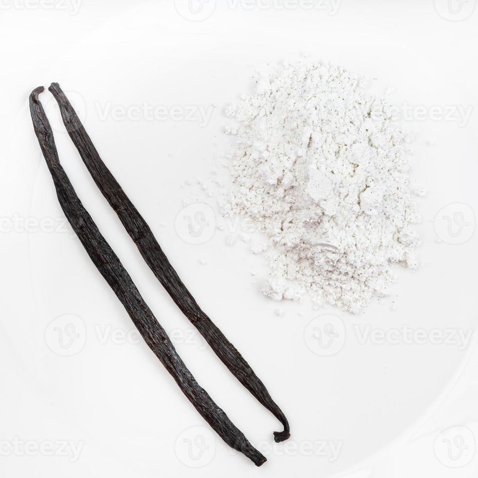 top view of vanilla pods and pile of vanilla sugar photo