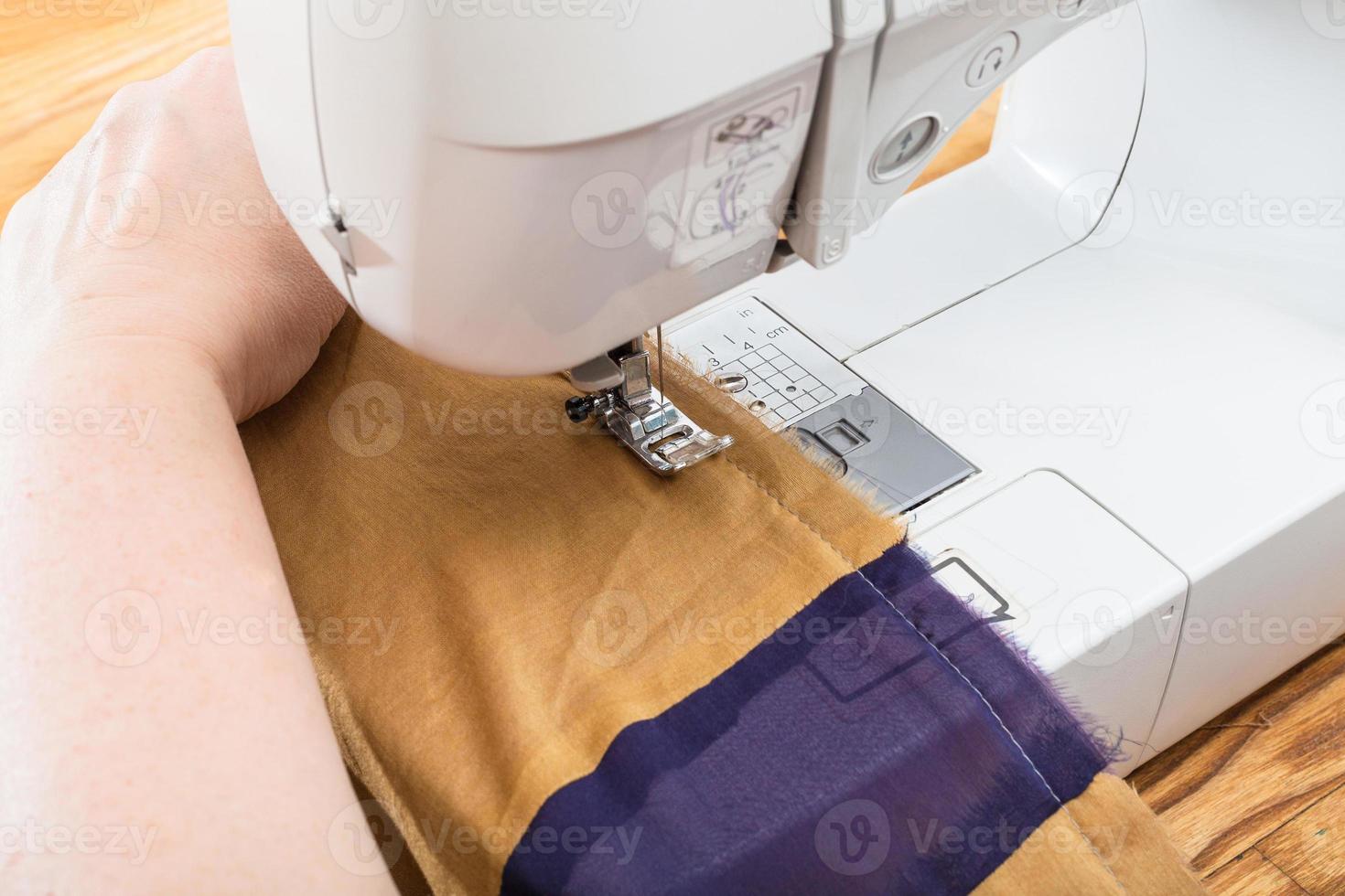 needlewoman stitches the silk patchwork scarf photo