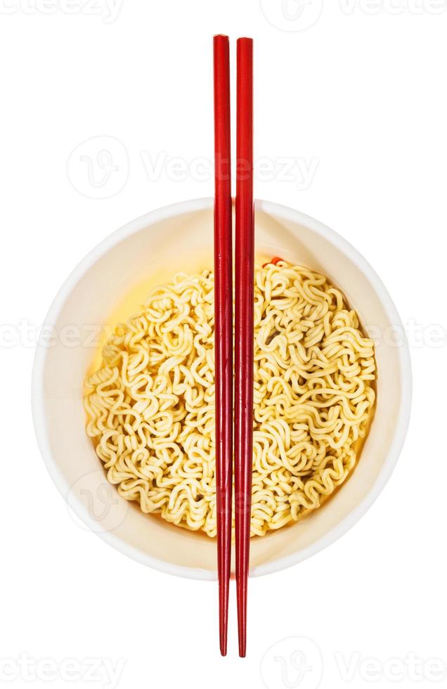 red chopsticks on open cup with instant noodles photo