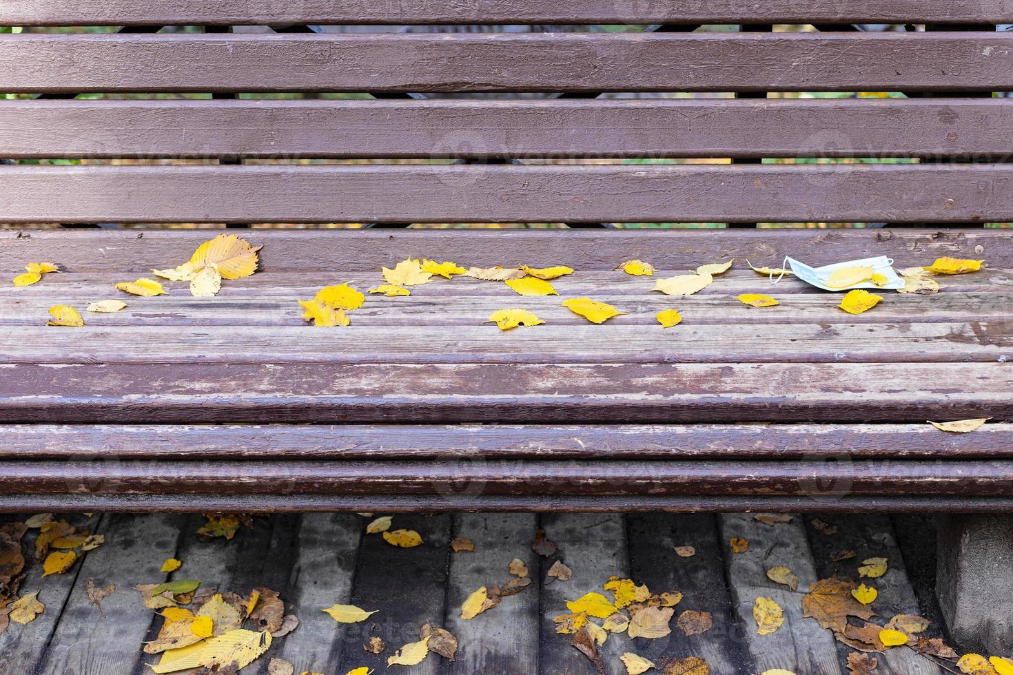 front view of bench with dropped sanitary mask photo