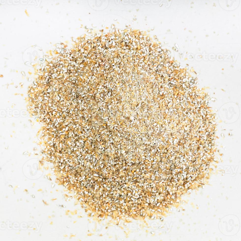 top view of pile of rye bran close up on gray photo
