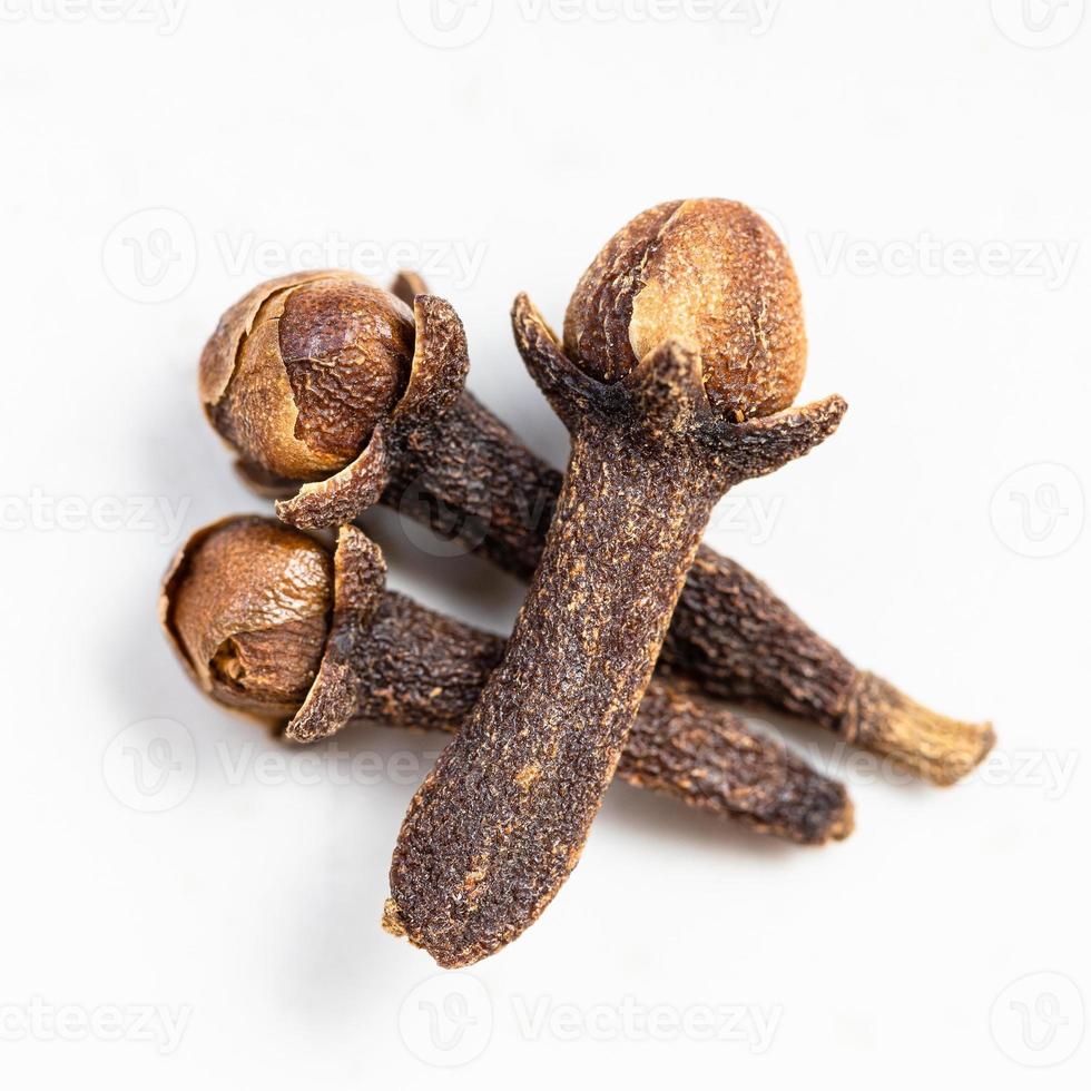 few whole dried cloves close up on gray photo