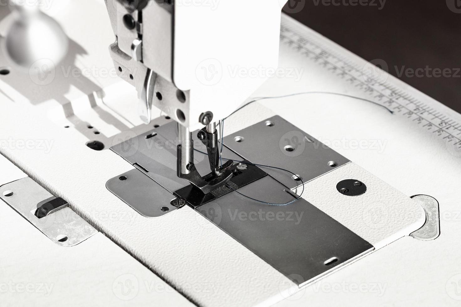presser foot of white industrial sewing machine photo