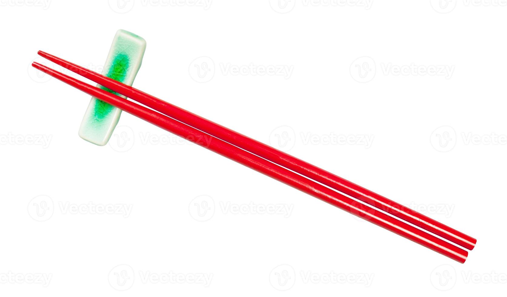top view of red chopsticks on chopstick rest photo