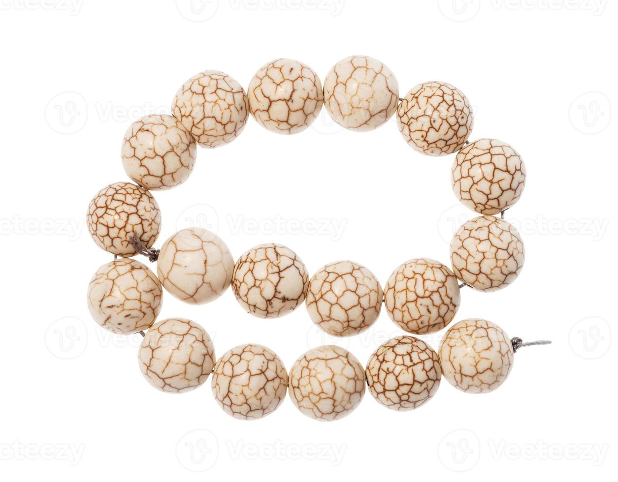 coiled string of beads from cacholong gemstone photo