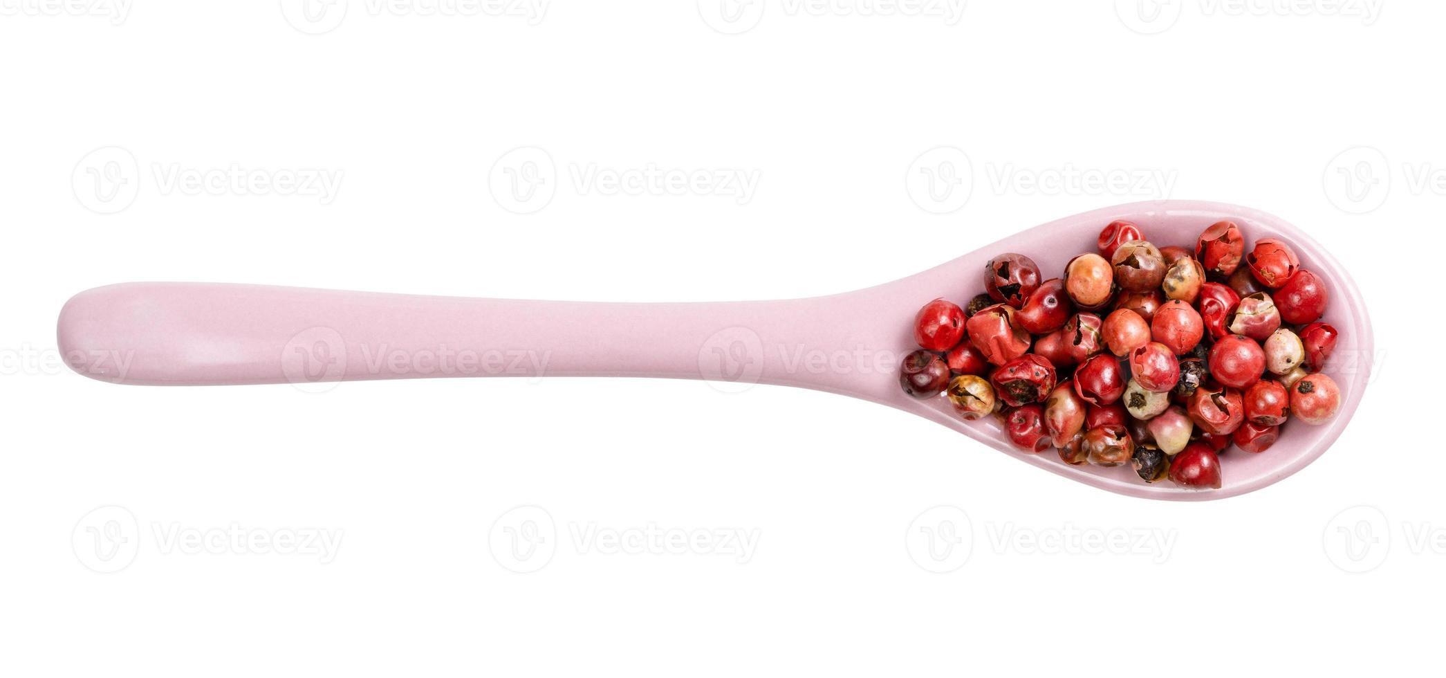 top view of ceramic spoon with pink peppercorns photo