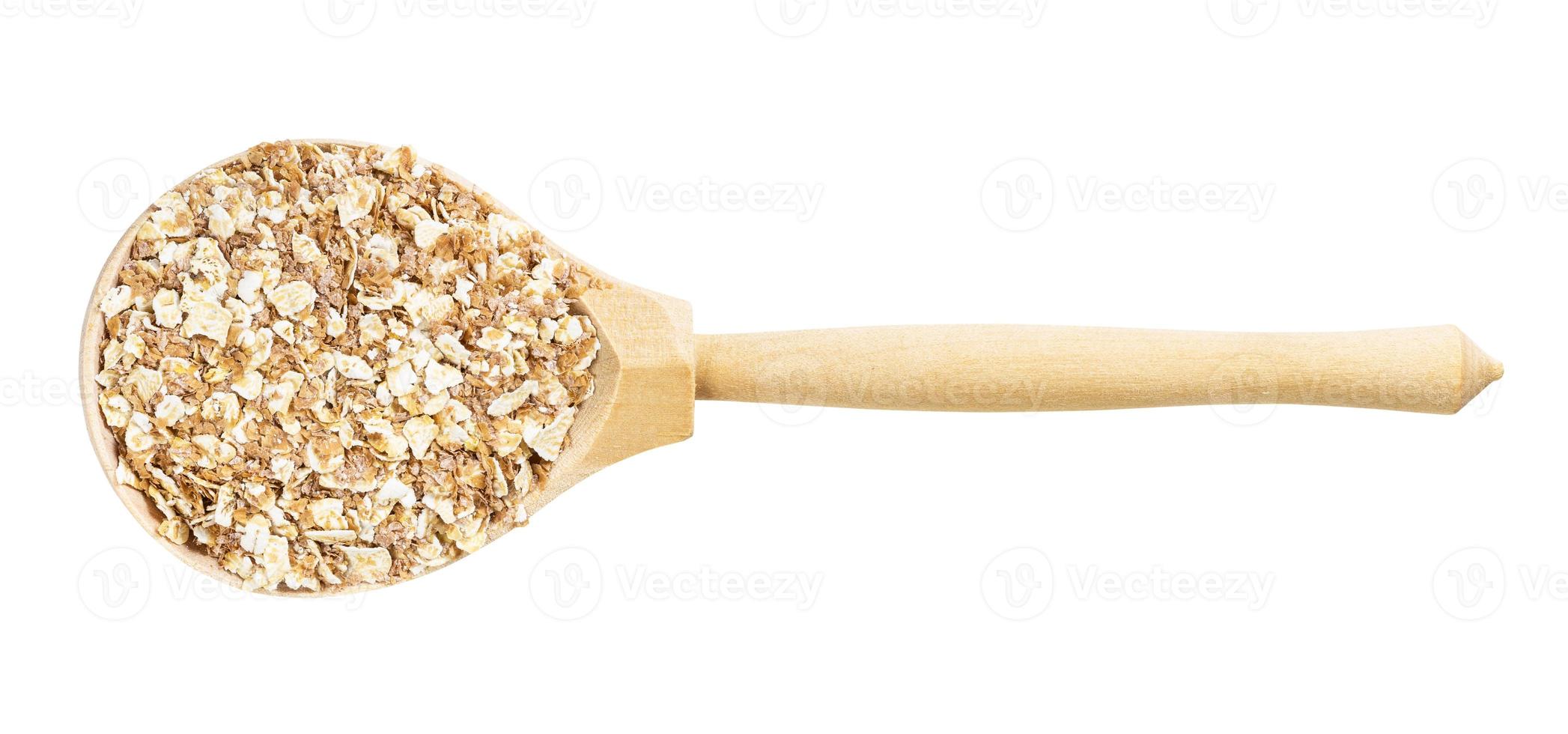 top view of spoon with oat flakes with rye bran photo