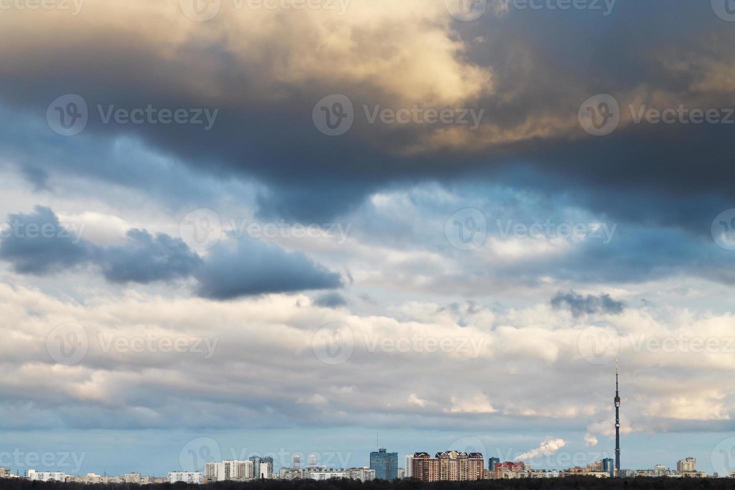 skyline with clouds in dark blue evening sky photo