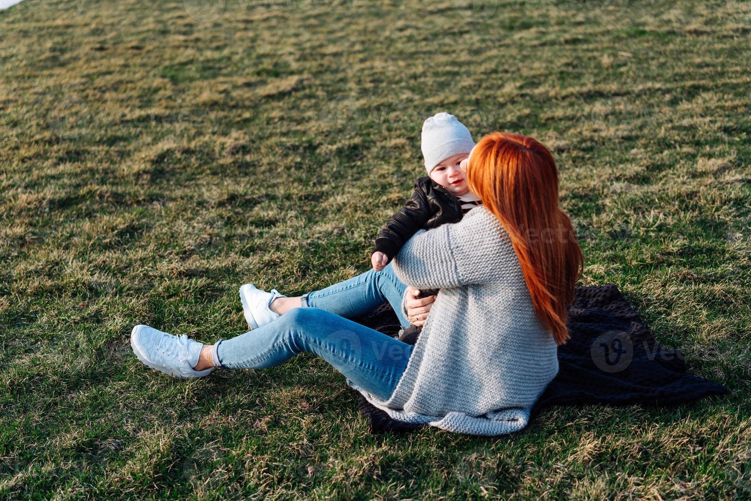 Mother and son on the grass photo