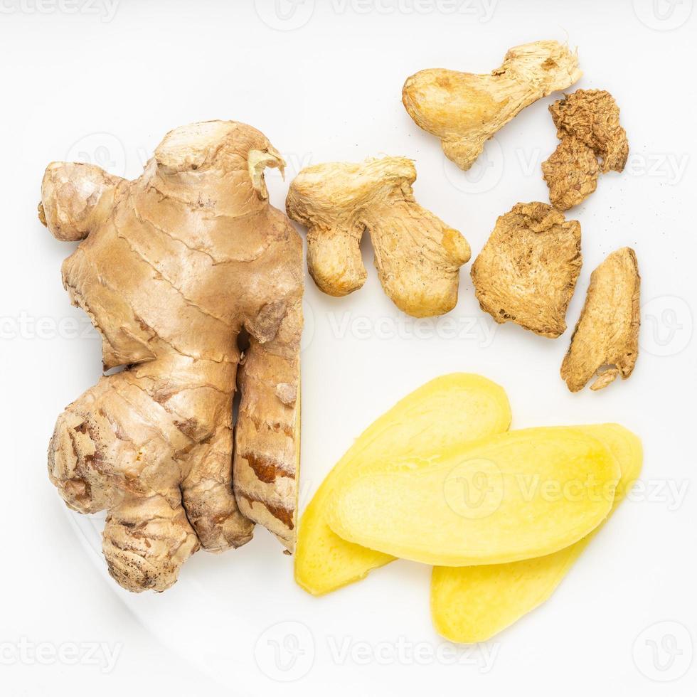 top view of sliced and dried ginger roots on gray photo