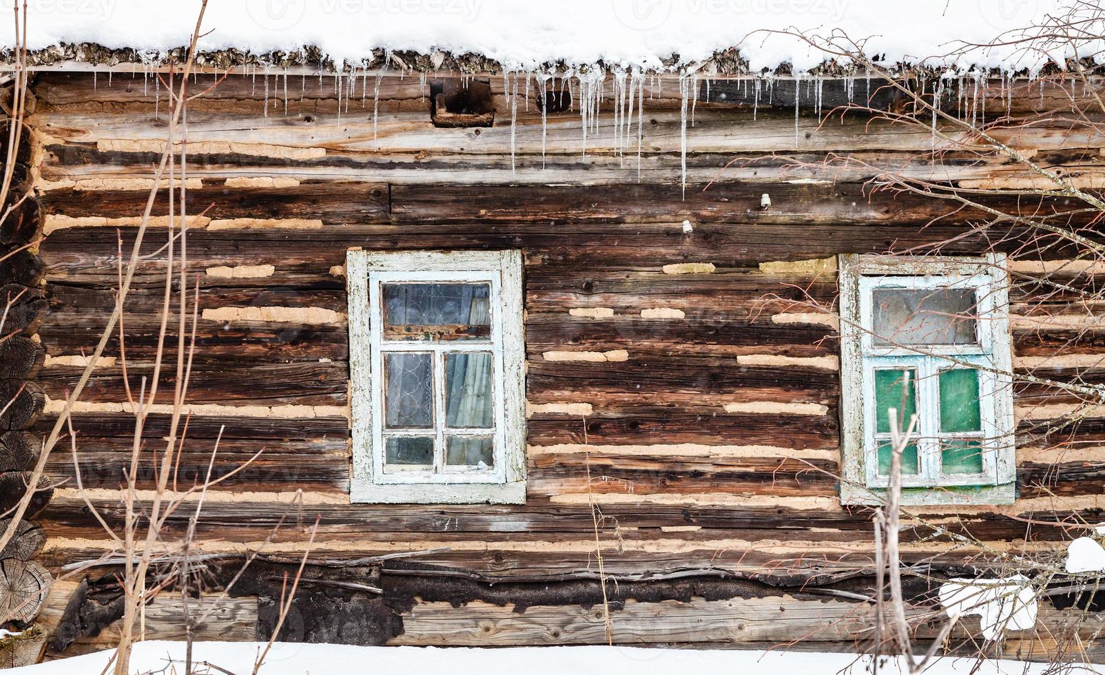 wood log wall with windows of old rural house photo