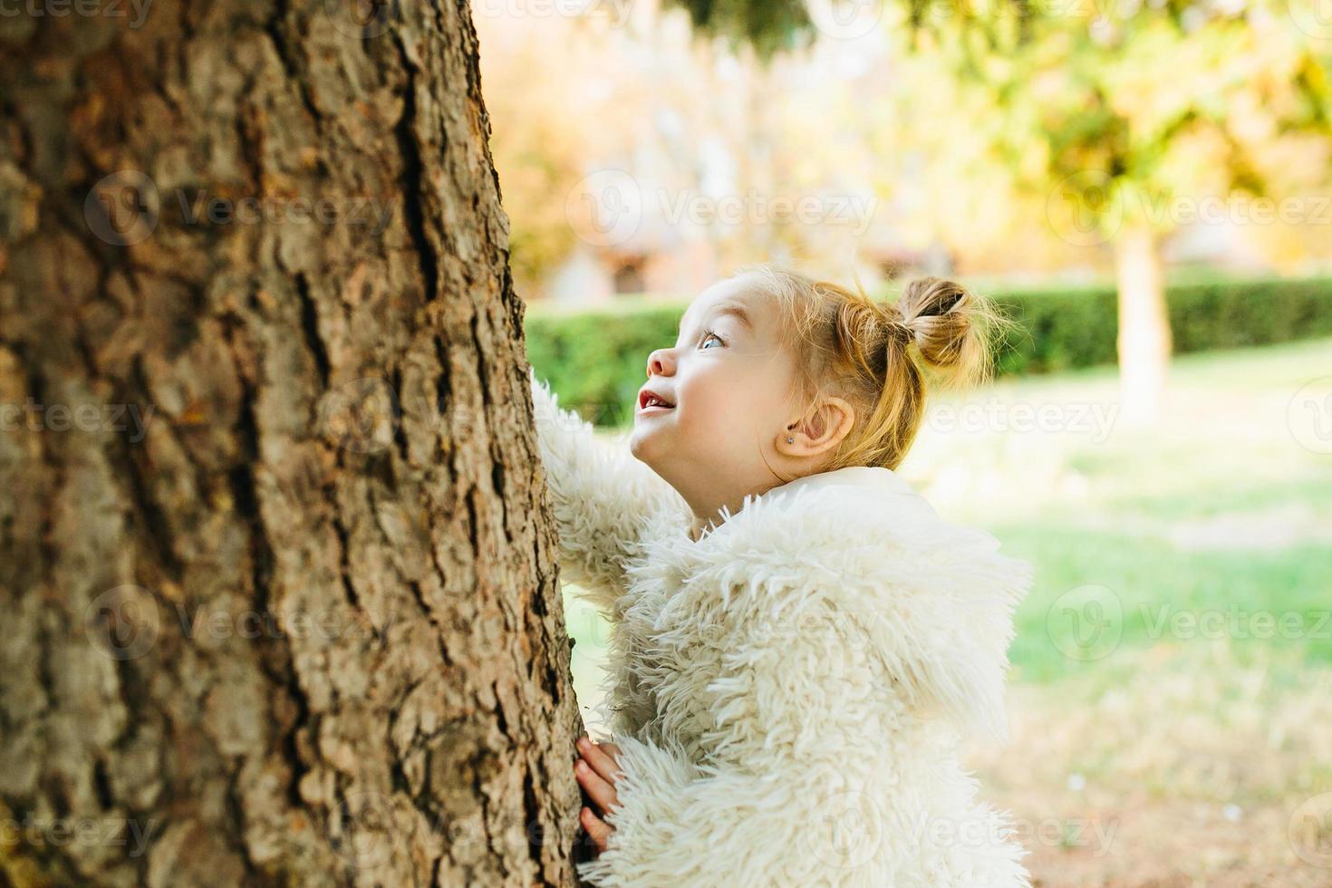 Cute little girl is playing outdoors photo