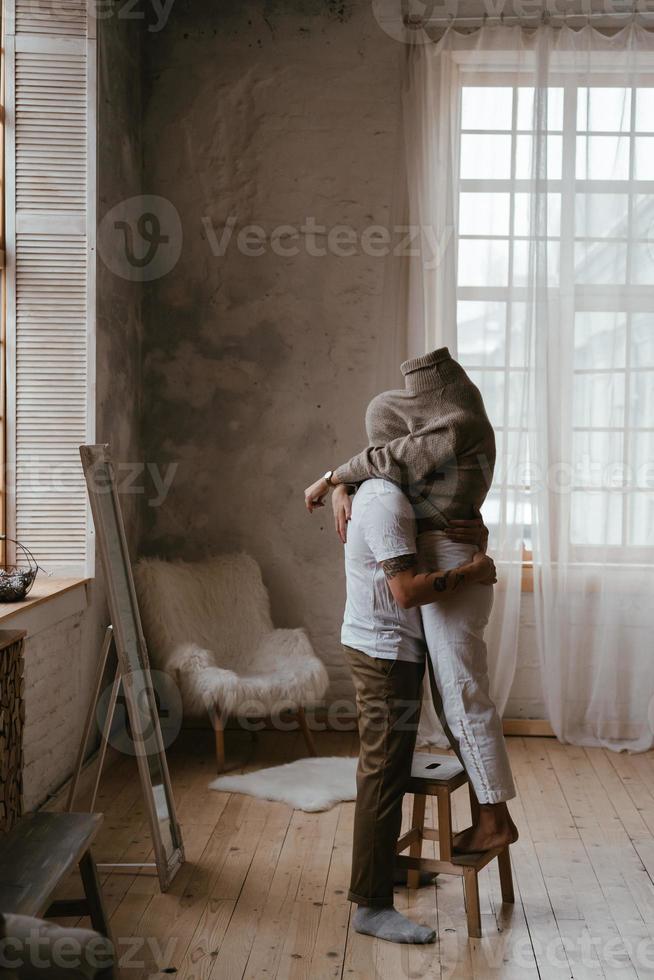 The guy and the girl in each other's arms in the room photo