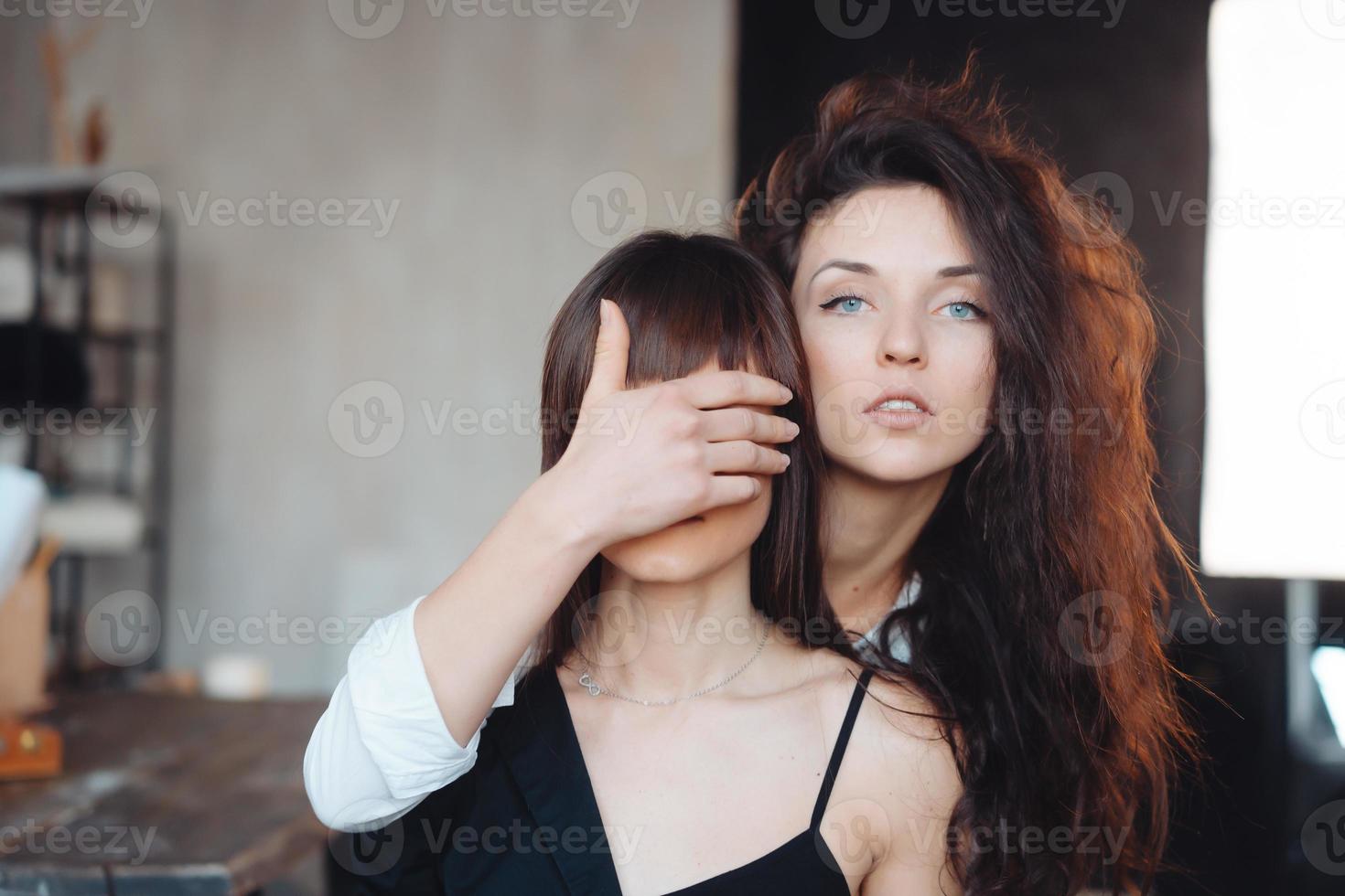 Girl holding hand and close eyes her girlfriend photo