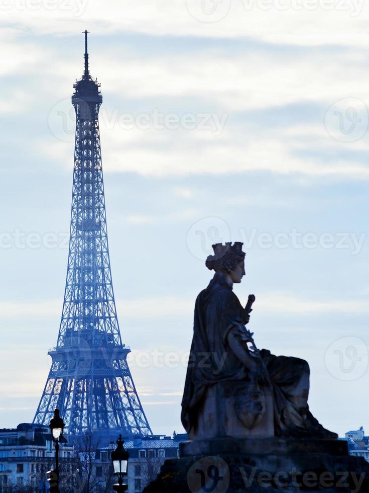 statue and Eiffel Tower in Paris photo