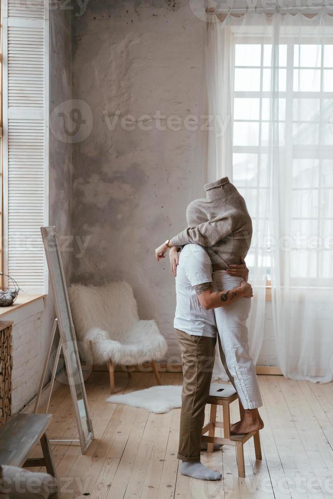 The guy and the girl in each other's arms in the room photo