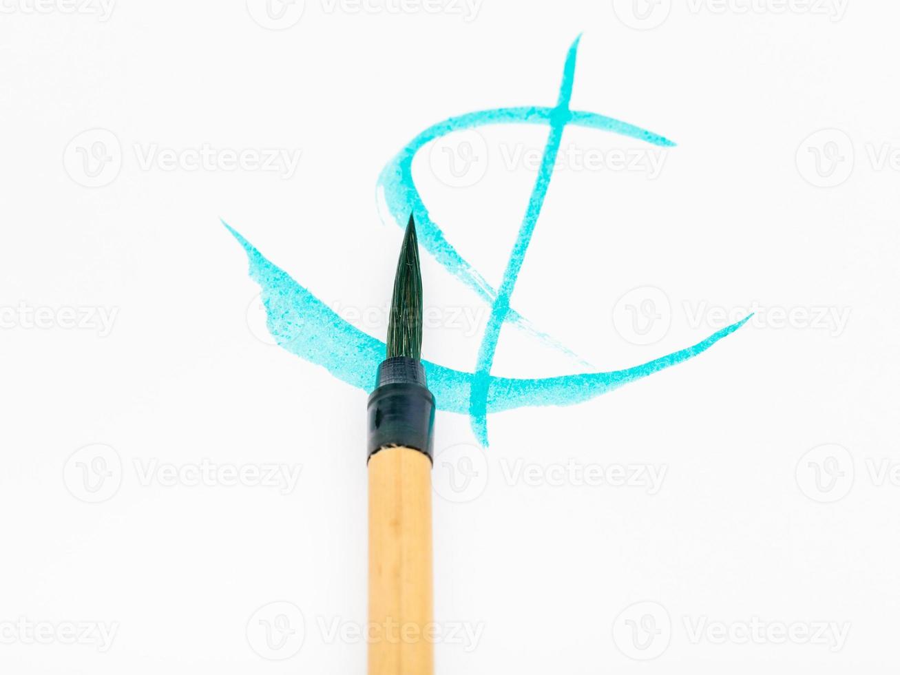 paintbrush with cyan tip over cyan brush strokes photo