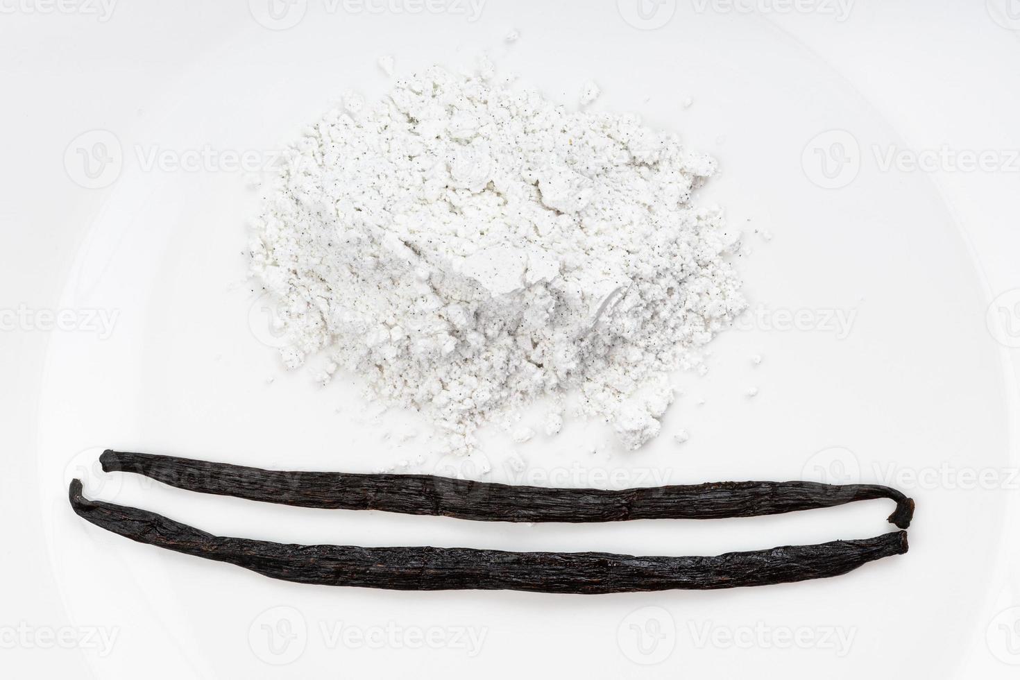 top view vanilla beans and pile of vanilla sugar photo