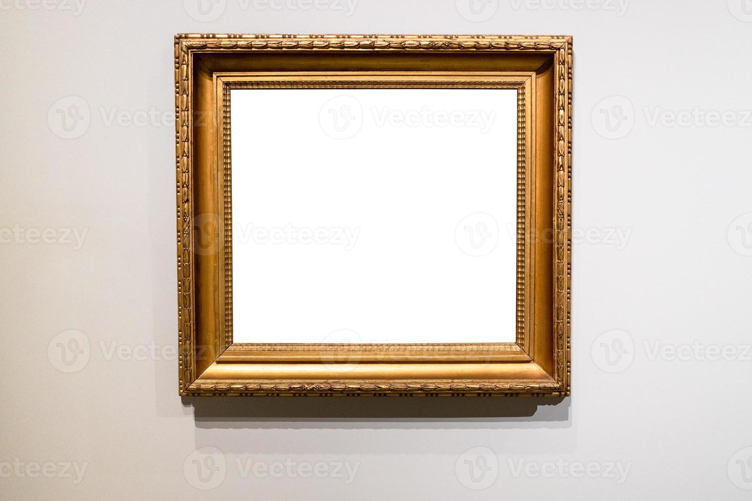 old wide golden picture frame on gray wall photo