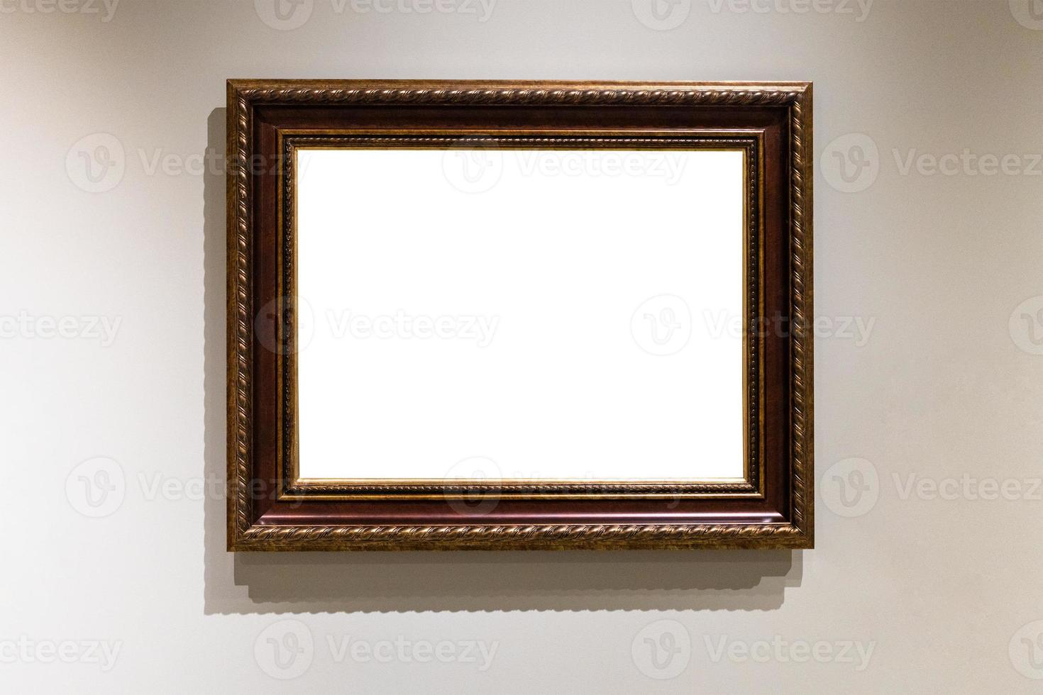 wide dark brown wooden picture frame on gray wall photo