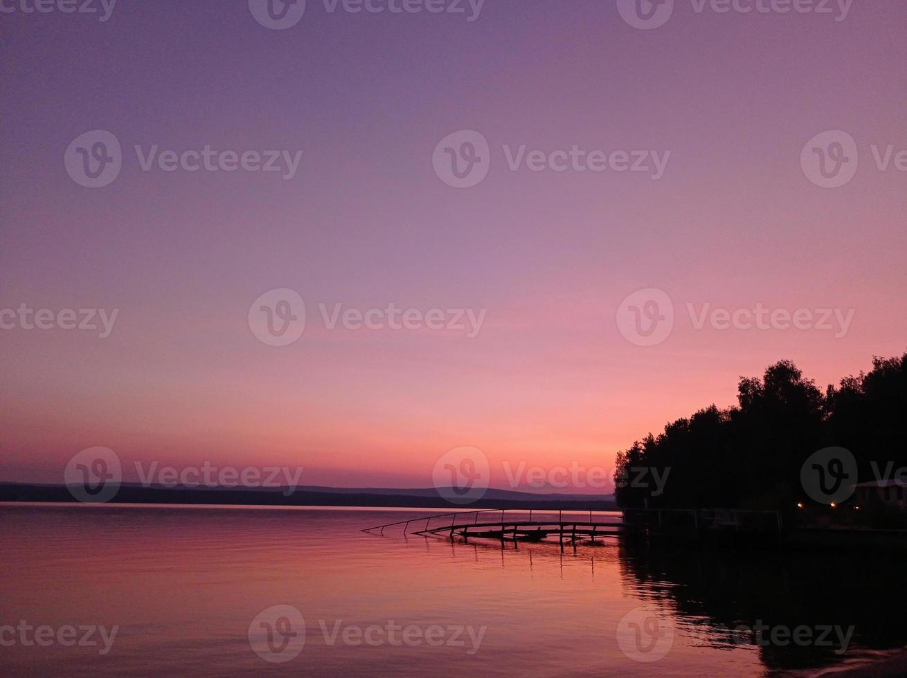 Beautiful pink sunset on the lake photo