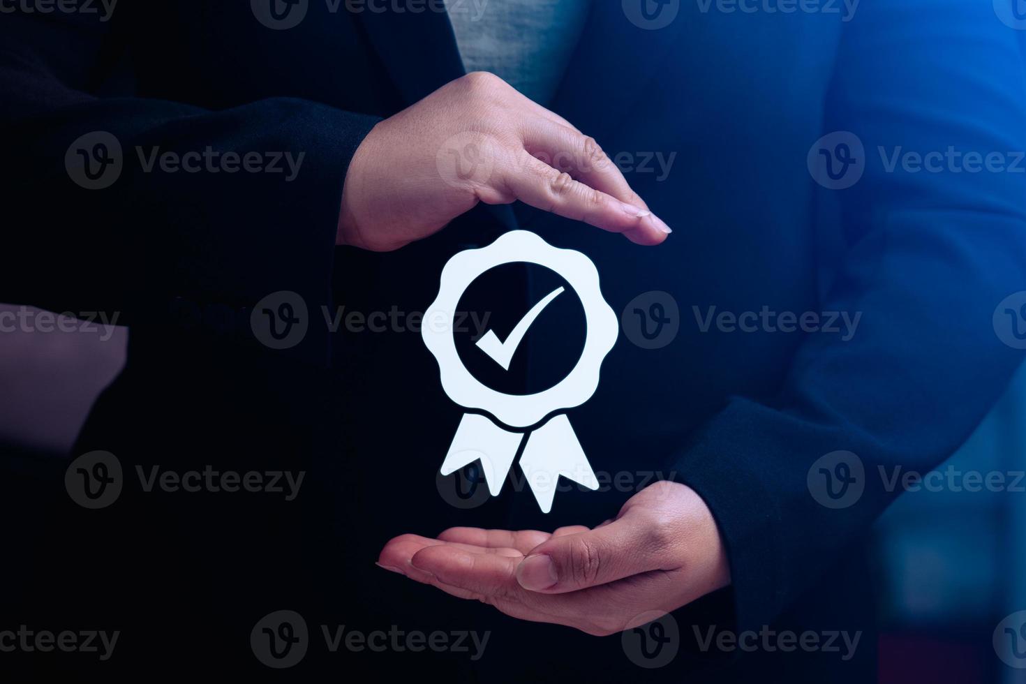 business woman's hand shows a symbol of quality assurance or certifying excellent manufacturing standards. ISO certification and standardization concepts. warranty, standards photo