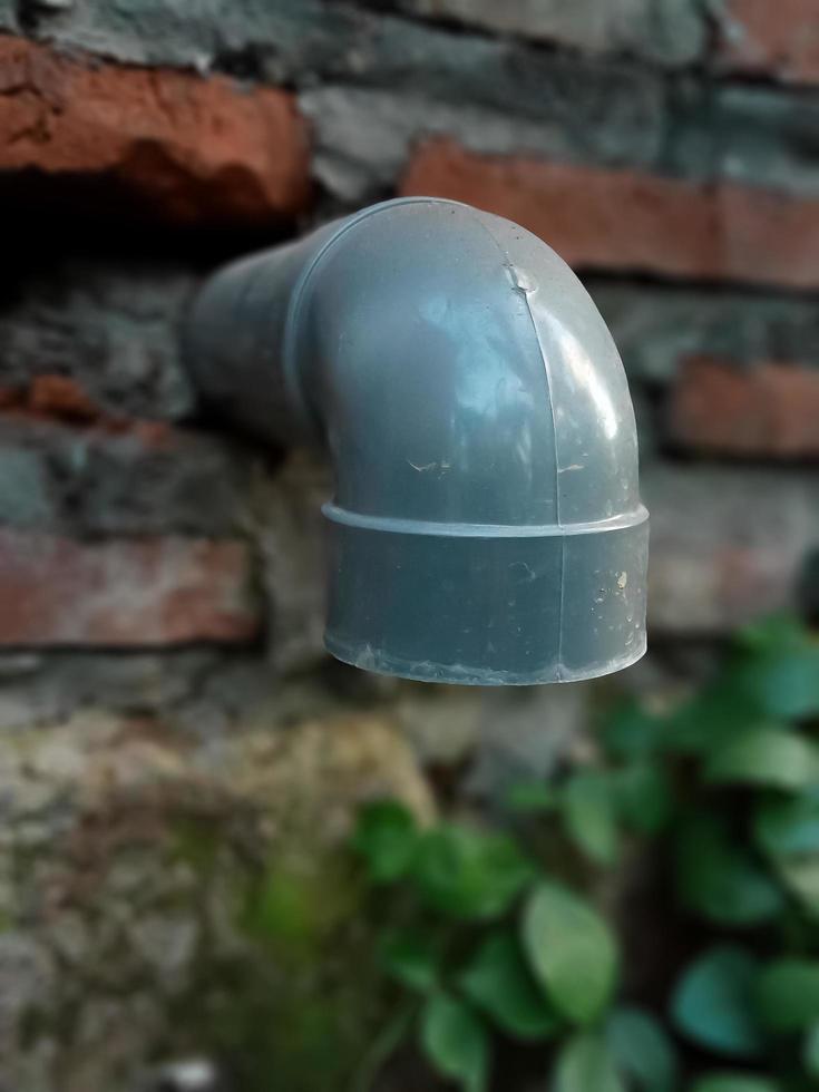 Sewer pipe on the wall of the house photo