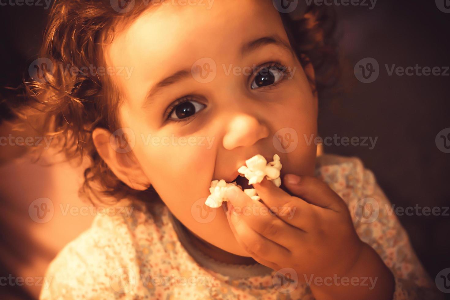 She really loves to eat popcorn. photo