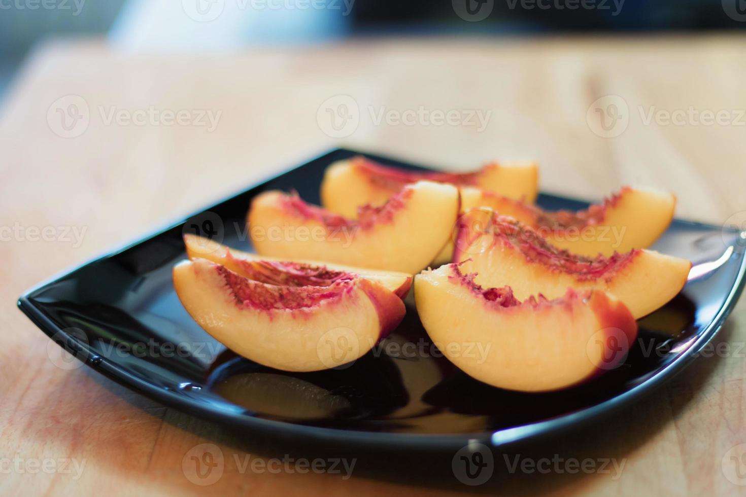 Sliced peach on a plate. photo