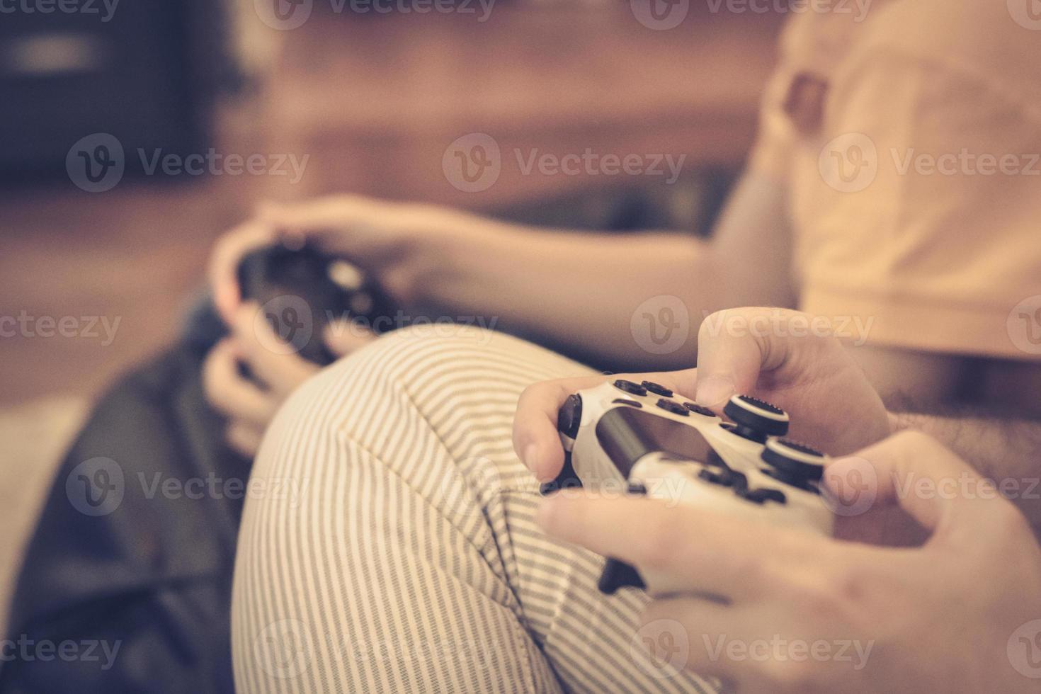 Close-up of father and son playing video games. photo