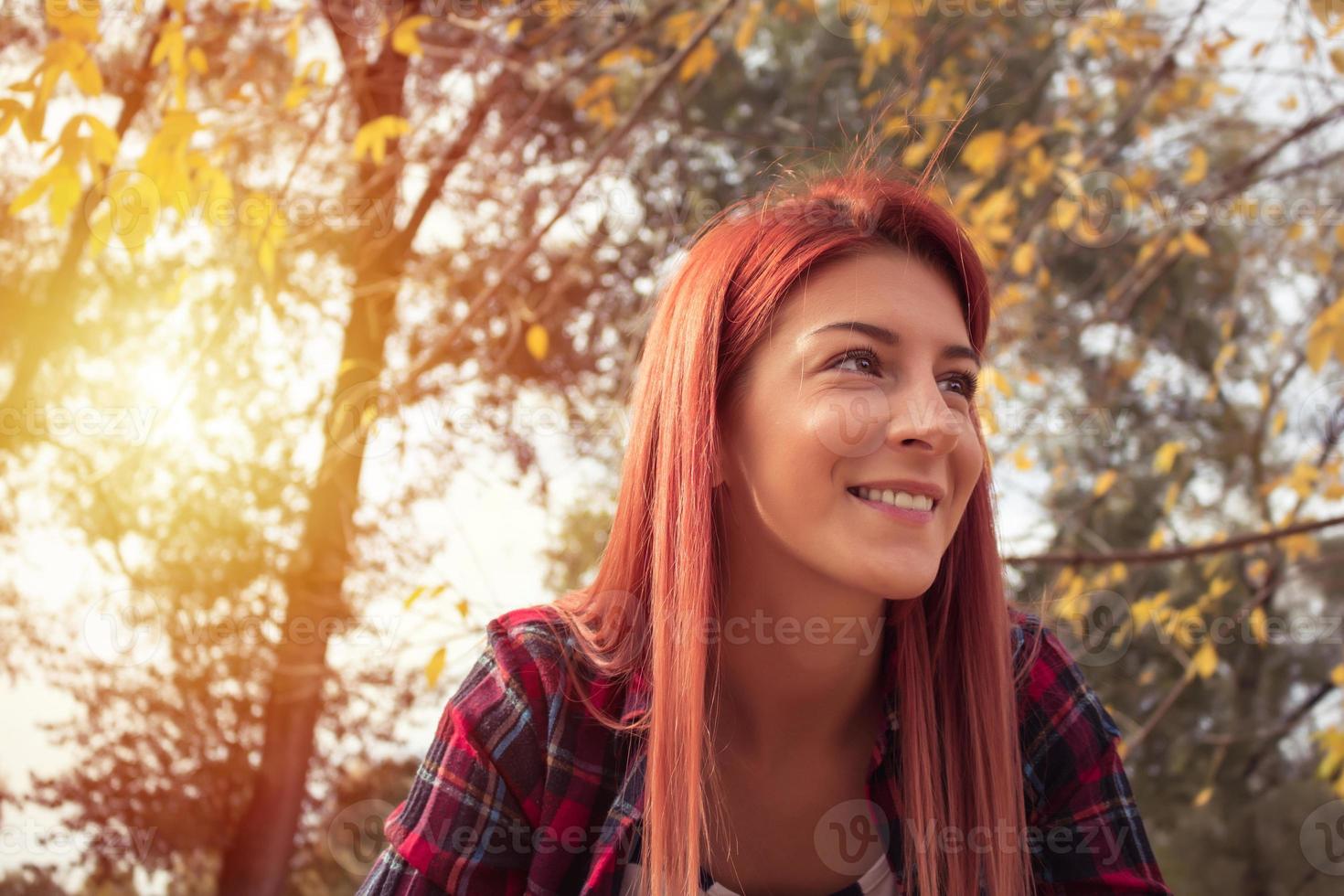 Portrait of beautiful redhead girl in the park. photo