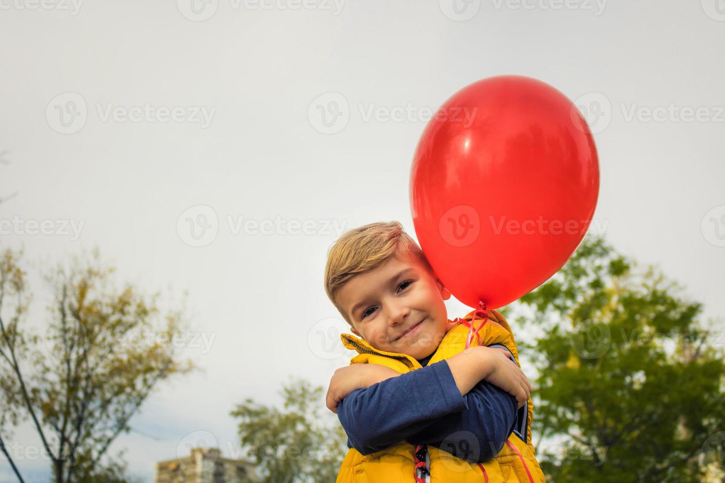 Happy boy with red balloon. photo