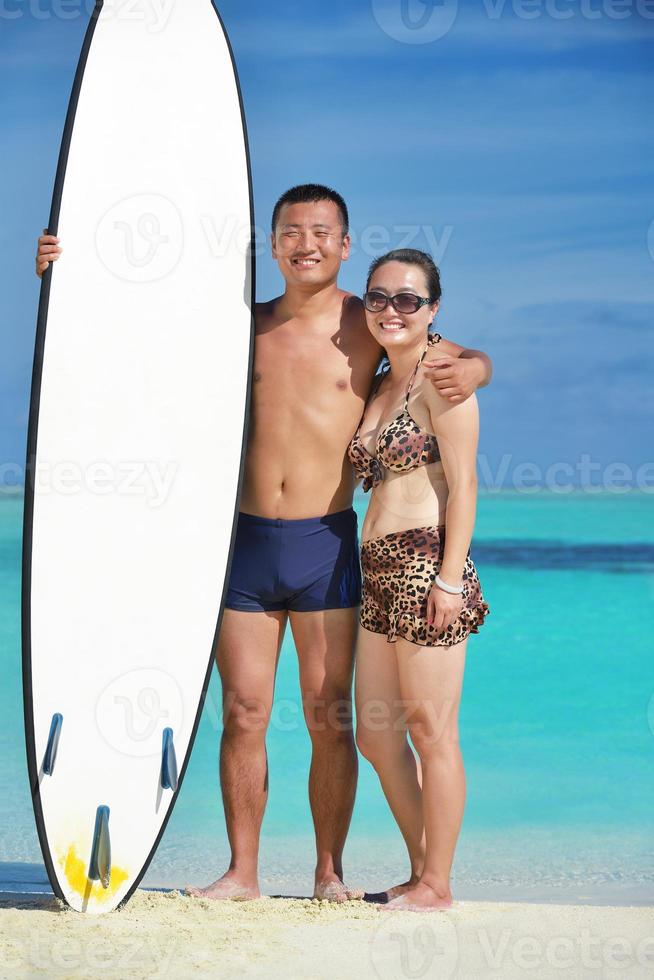 happy young  couple enjoying summer on beach photo