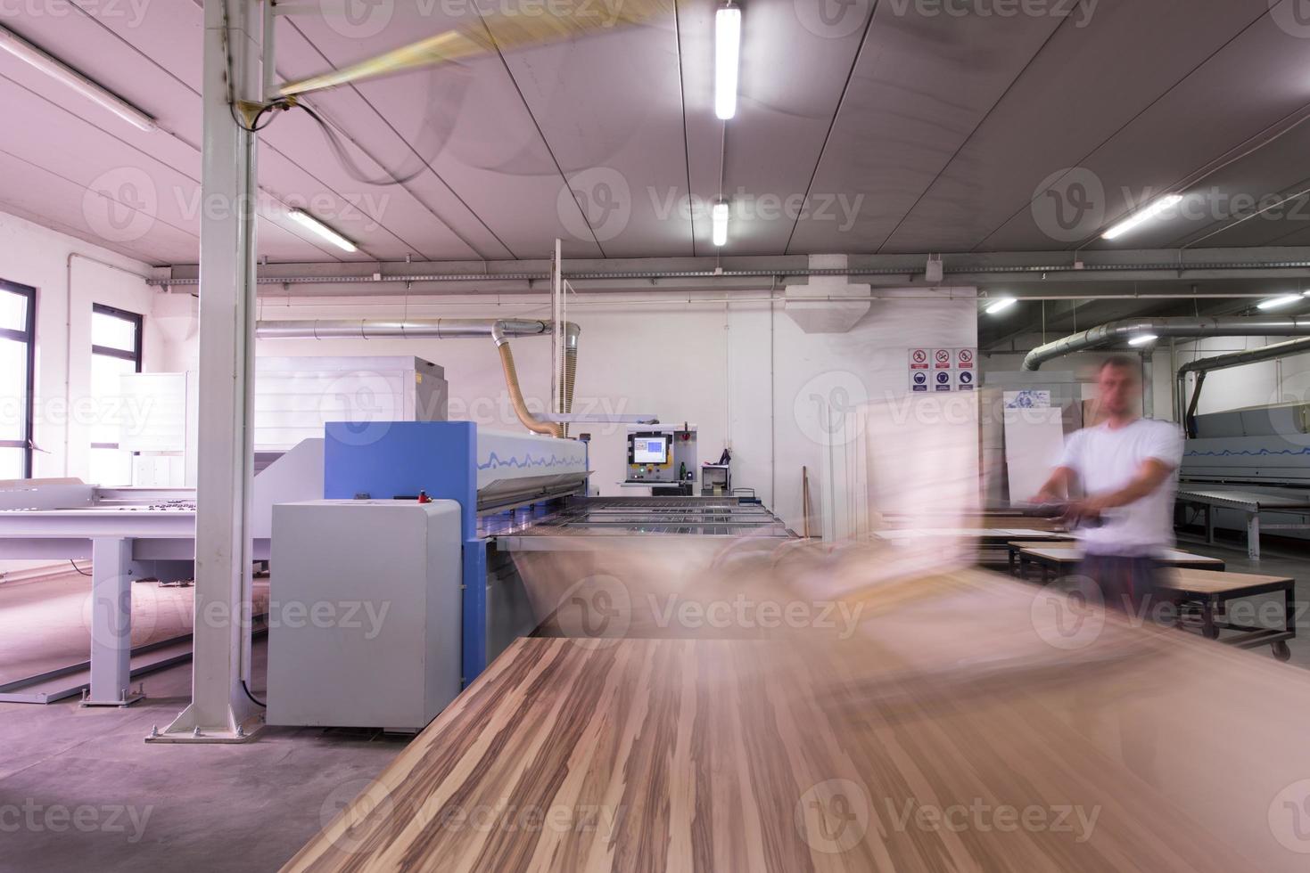 worker in a factory of wooden furniture photo