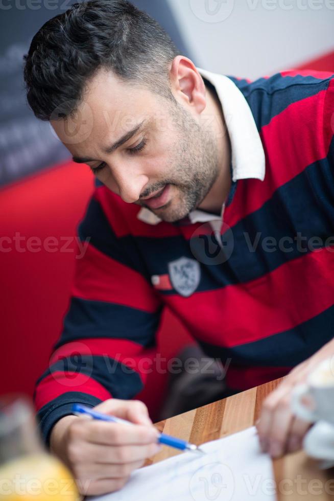 designer with a pen sketching his idea photo