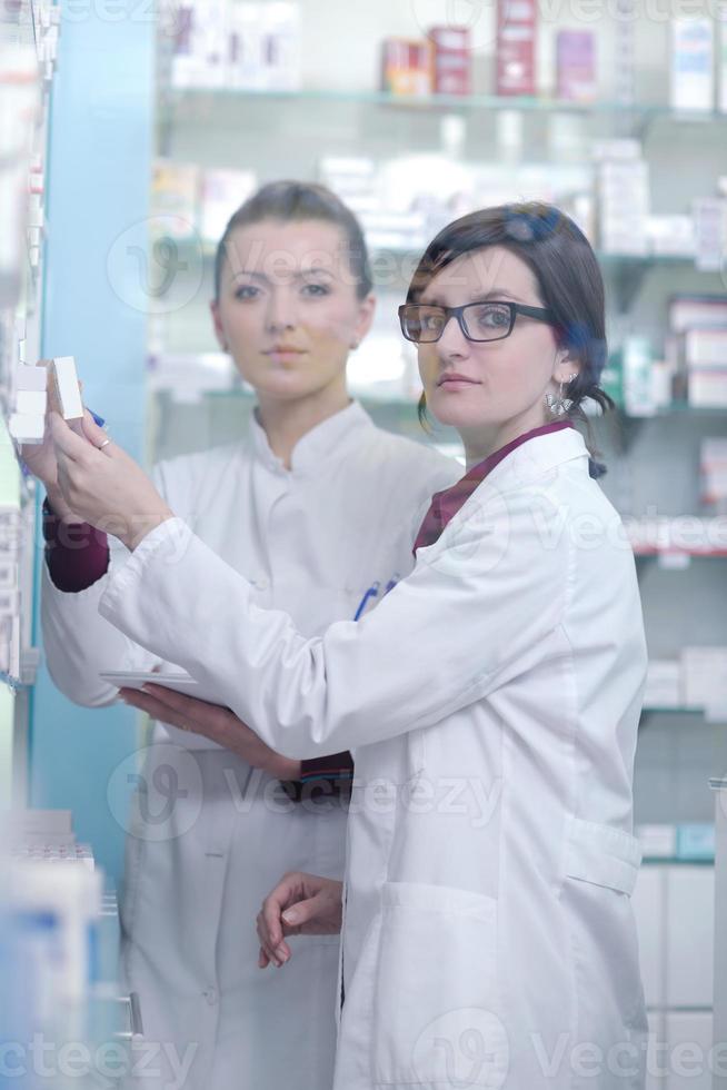 team of pharmacist chemist woman  in pharmacy drugstore photo