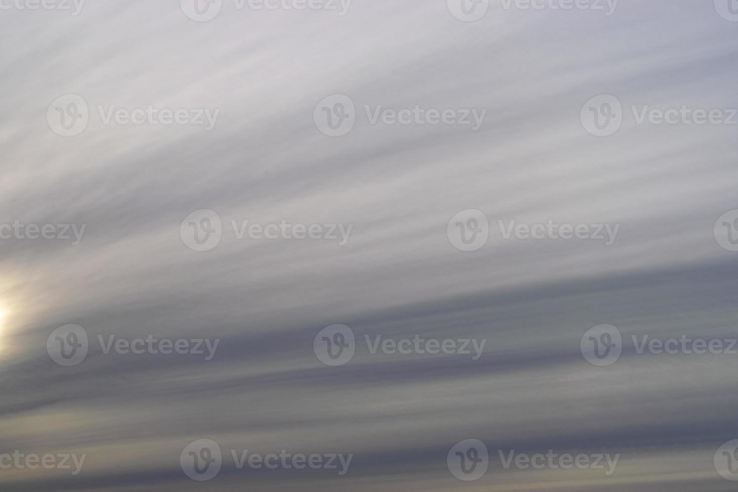 Dramatic blue sky and warm light clouds at sunrise time. photo