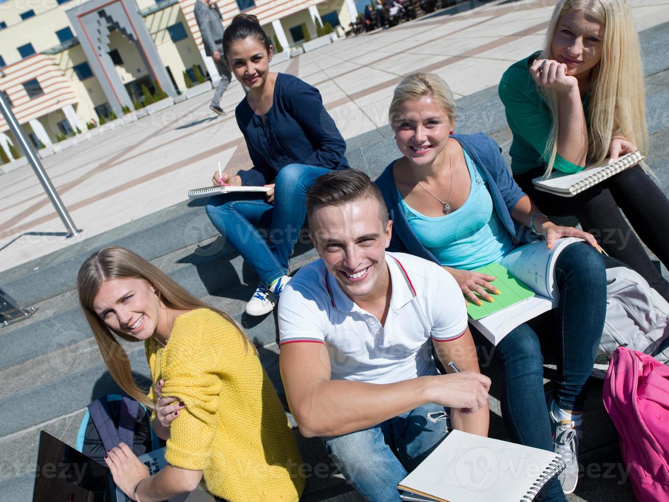 students outside sitting on steps photo