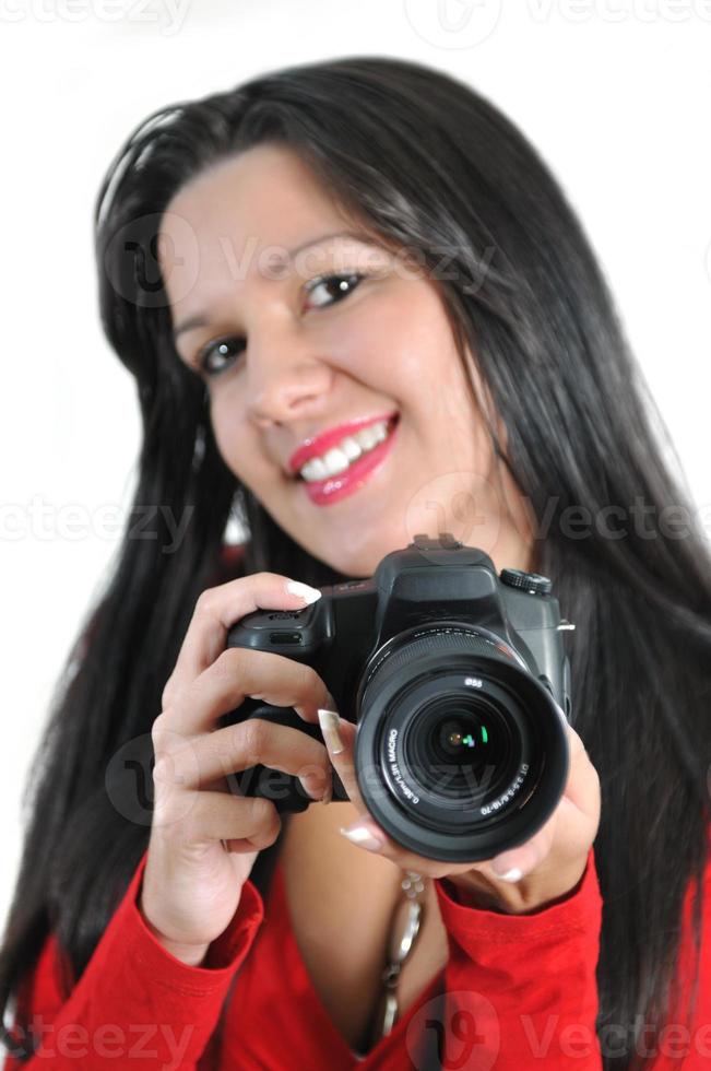 Young woman holding camera in hand taking picture isolated photo