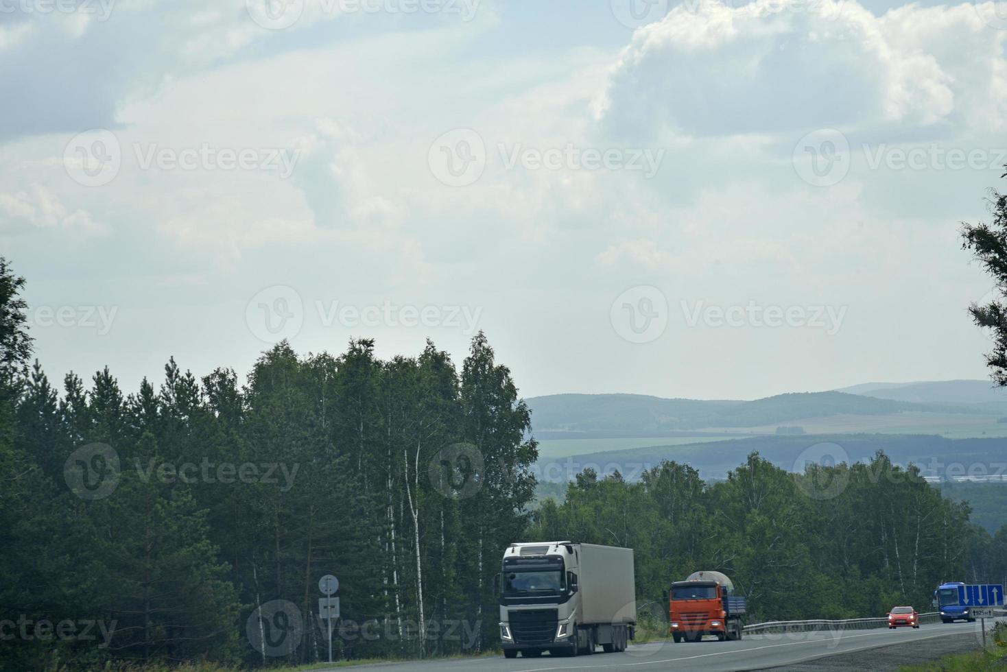 A high-speed road in the Ural Mountains in Russia. Cargo and passenger transport on the mountain road. photo