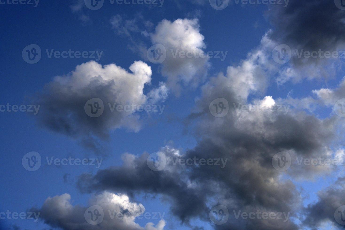 Silvery clouds in the blue sky in the evening. Beautiful blue clouds on a summer evening. photo