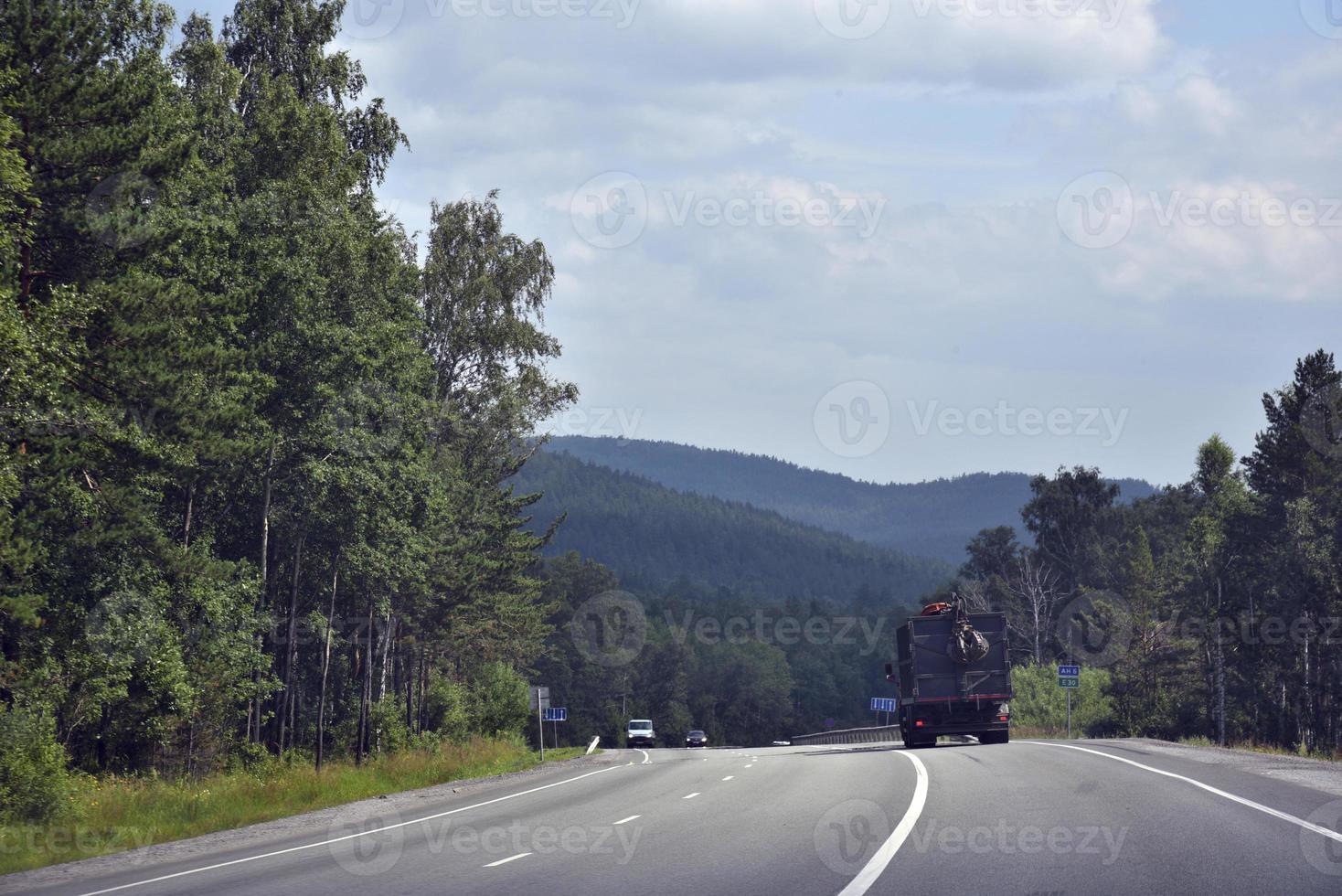 A high-speed road in the Ural Mountains in Russia. Cargo and passenger transport on the mountain road. photo