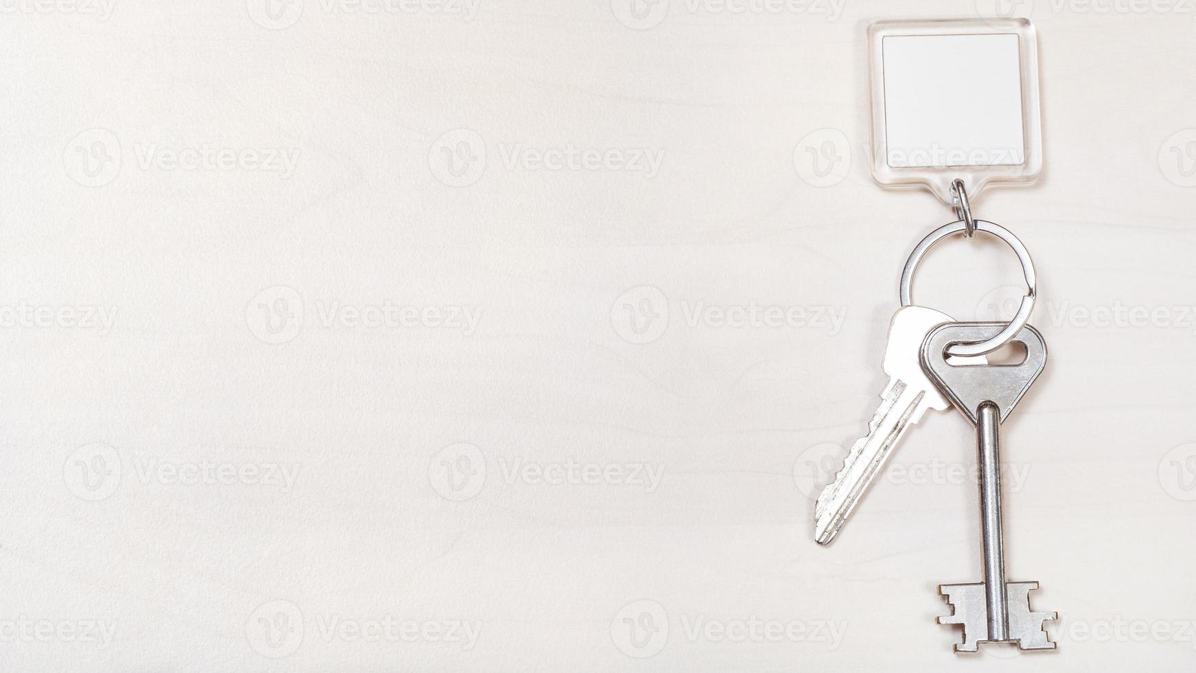 keys on keyring with blank white keychain on board photo