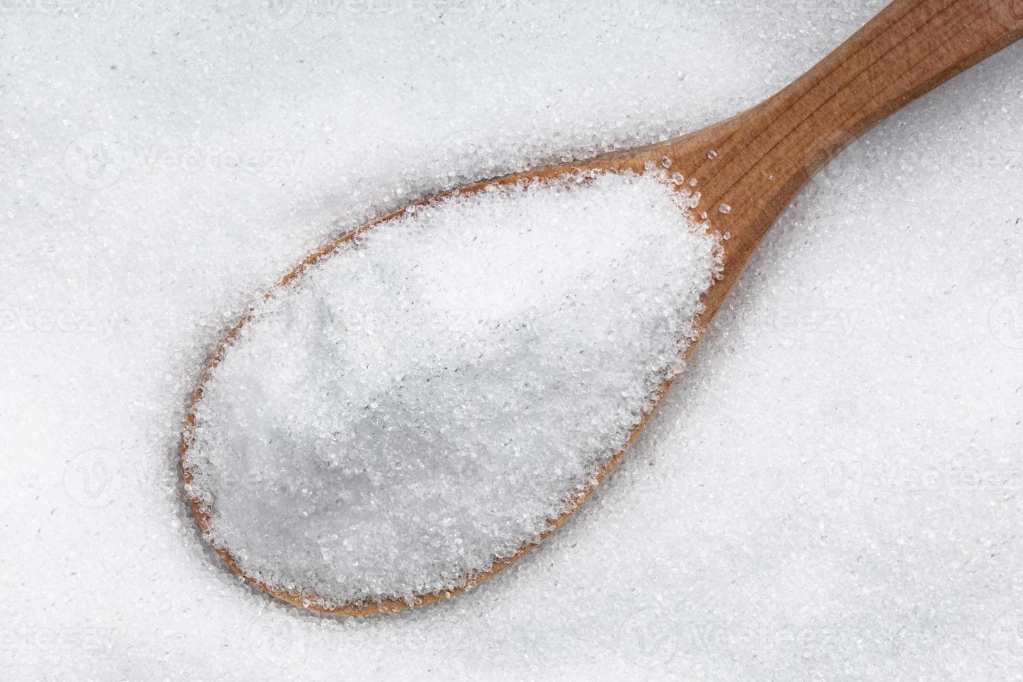 top view of wood spoon with crystalline erythritol photo